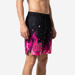 Black and pink flame sublimated basketball shorts shown from a three-quarter angle, player number 00 visible on the side thigh panel