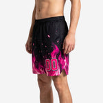 Side view of black custom basketball shorts with full pink flame sublimation print and side split hem detail