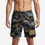 Black custom basketball shorts with gold lightning-crack camo print and player number 00 on right thigh, front view, made to order for adult teams