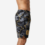Side view of custom black and gold camo basketball shorts showing elastic waistband, drawcord, and 2-inch side split at the hem