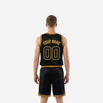 Opposite side view of black and gold custom basketball uniform set showing matching shorts side panel stripe and jersey silhouette