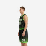 Opposite side view of custom black and green basketball uniform highlighting armhole trim and shorts hem binding