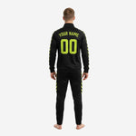 Close-up of black soccer tracksuit jacket with neon yellow sublimated chevron sleeve trim and stand collar full-zip detail