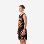 Second side view of custom boys basketball uniform in black and orange with diagonal slash design on jersey and shorts legs