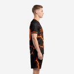 Side view of black and orange lava soccer uniform kit with glowing crack pattern