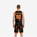 Side view of black and orange reverse side of the reversible basketball uniform showing contrast trim and shorts hem binding