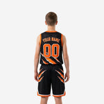 Back view of black and orange youth basketball uniform showing jersey and shorts with matching claw-print sublimated design