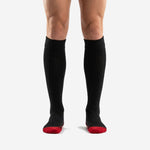 Front view of red and black soccer socks with jet black over-the-calf body and red toe contrast zone