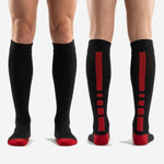 Full-length pair of custom red and black soccer socks displayed over the calf with ribbed cuff band