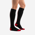 Side panel view of black and red soccer socks showing red calf panel stripe and ribbed elastic cuff