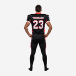 Opposite side view of black red American football uniform set showing sleeve number placement and red side panel on jersey body