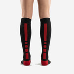Heel detail of black over-the-calf team soccer socks with red cushioned heel contrast panel