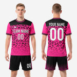 Black soccer shorts with hot pink side stripe and faded leopard print detail at hem matching the jersey kit