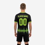 Close-up of lime green soundwave sublimation print on black soccer training jersey lower hem zone