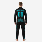 Close detail of black custom soccer tracksuit jacket with stand collar, full zip, and teal sublimated chest print zones