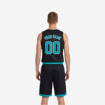 Side view of black reversible basketball jersey with teal armhole binding and teal trim on matching shorts