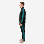 Second side view of black and teal soccer tracksuit highlighting teal triangle panel construction on tapered pants