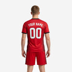Close detail of black V-neck collar and black cuff trim on sublimated red soccer jersey