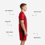 Detail of red soccer shorts with black side stripe and sublimated player number on left leg