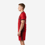 Right side view of custom red soccer uniform showing black side stripe on matching red shorts