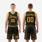 Full set view of custom black and yellow basketball uniforms showing matching jersey and shorts worn by adult male model