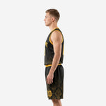 Close detail of black and gold basketball shorts showing damask pattern on lower leg and gold number on the hem area