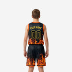 Opposite side view of custom black youth basketball uniform set showing orange hem trim on shorts and full-coverage flame graphic detail