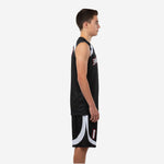 Front view of custom black and white youth basketball uniform set with arced team name across chest and player number on jersey and shorts