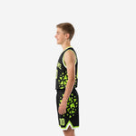 Side view of black youth basketball jersey and shorts showing neon green triangle pattern running from armhole to shorts hem