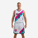 Blank basketball uniforms in white with hot pink and aqua diagonal sash panels, front view full set