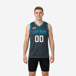 Custom blue and gray basketball jersey with teal V-neck binding and arched team name across the charcoal chest, front view on male model