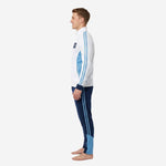 Right side view of custom blue and white soccer tracksuit displaying three-stripe powder blue sleeve and navy ankle panel on tapered pants