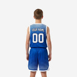 Back view of custom blue and white youth basketball uniform displaying back name and number on royal blue sublimated jersey and matching shorts