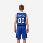 Opposite side view of the royal blue youth basketball jersey and shorts set showing white armhole binding and shorts side stripe detail