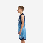 Side view of custom navy and sky blue youth basketball uniform showing hex pattern on lower jersey body and shorts with navy hem band
