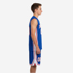 Side view of royal blue youth basketball uniform set showing white jersey side panel with red trim stripe and matching shorts white side panel