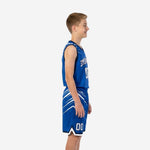 Side view of royal blue and white youth basketball uniform showing diagonal slash pattern on jersey and shorts with navy binding