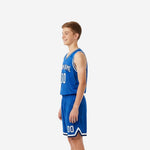 Side view of blue and white youth basketball uniform set showing V-neck binding and shorts chevron hem detail