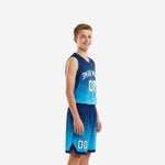 Side view of navy and cyan custom youth basketball uniforms showing gradient fade pattern on jersey and shorts with white number 00
