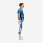 Side view of custom blue and white youth football uniform showing navy side panel on jersey and full-length navy and sky-blue leg stripe on white pant