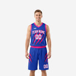 Custom blue basketball uniforms in royal blue and hot pink with claw-mark sublimation, team name arced on chest and front number 00 on jersey and shorts, front view full set