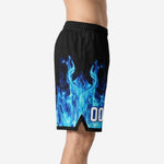 Side view of custom basketball shorts for schools showing blue flame pattern rising from hem with black side split and hem binding