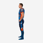 Custom football uniforms for youth teams in royal blue and orange - opposite side profile showing orange side panel taper and full-length navy pant construction