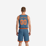 Steel blue reversible basketball uniform side view showing topographic contour pattern, orange armhole binding, and matching shorts side panel