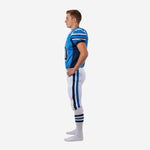 Side view of blue youth football uniform showing navy side panel on jersey and full-length blue and navy stripe on white pants