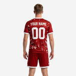 Detail view of bold crimson custom soccer uniform chest showing white shatter pattern and V-neck contrast trim
