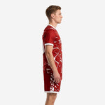 Custom red and black soccer uniforms side view showing white shatter-burst pattern wrapping around crimson jersey and shorts