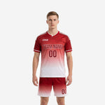 Bold dark red custom red soccer uniform with gradient fade to white, front view on male model, full kit jersey and shorts