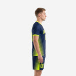 Side view of men's navy blue custom yellow soccer uniform showing neon yellow diagonal stripe panels on jersey and shorts