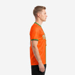 Bold orange soccer jersey with Kelly Green sleeve cuff trim, left side view on male model